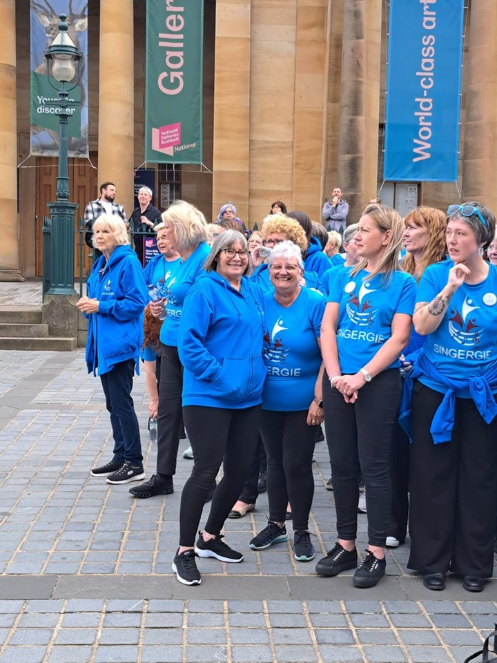 A group of Singergie members preparing to perform